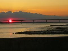 A serene island bathed in the beauty of a sunset