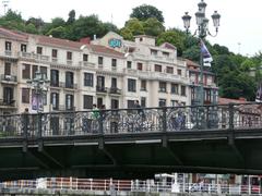 Cyclists crossing the Ajuntament Bridge in Bilbao