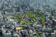 green zone in the middle of grey urban area in Osaka, Japan with a temple or shrine