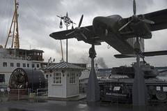 Military objects including planes, submarines, and a tank displayed together