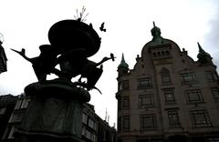 Copenhagen Amager Torv with people walking in the square, historic buildings in the background