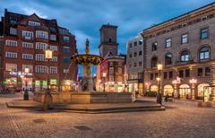 Caritasbrønden fountain illuminated at night