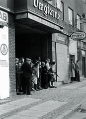 Danish resistance fighters and civilians taking cover in a street in Aalborg during liberation on May 4-5, 1945