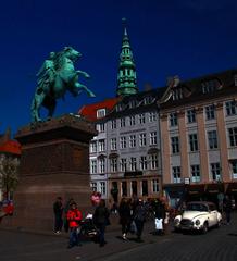 Højbro Plads in Copenhagen with people enjoying the square and historical buildings in the background