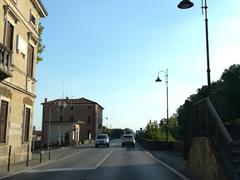 a picturesque view of Battaglia Terme with vibrant greenery and historical architecture under a bright blue sky