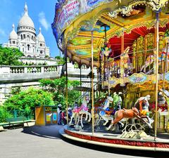 Vintage carousel at Square Louise-Michel with Sacré-Cœur in the background