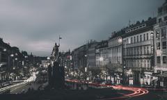 Dim evening city life with light trails