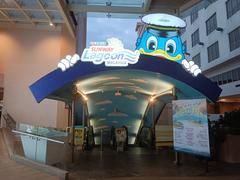 Sunway Lagoon entrance with colorful sign and a fountain