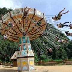 Dragon Flight roller coaster in amusement park with blue sky