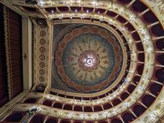 Inside Rossini Theater in Pesaro with red seats and ornate balconies