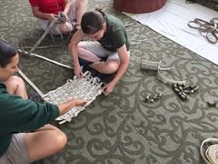 Animal keepers in a workshop creating animal enrichment items from fire hoses