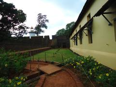 Thalassery Fort compound with green lawn and stone pathway