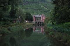 Munnar dam surrounded by lush greenery and hills