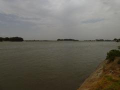 Grand Anaikat dam in Tamil Nadu, India with surrounding greenery and a cloudy sky