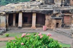 cave opening with tree and moss-covered entrance