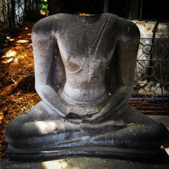 Broken Buddha statues and Hindu temples ruins