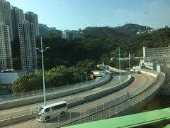 Ap Lei Chau Bridge with people walking and high-rise buildings in the background