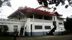 Aguinaldo Shrine with Philippine flag under a clear blue sky