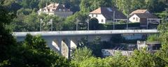 Viaduc de la Jonction viewed from Bois de la Bâtie with graffiti on the bridge and loading dock