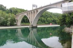 Pont de la Jonction bridge over a river with trees in the background