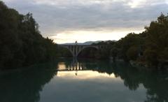 Viaduc de la Jonction bridge spanning a railway, surrounded by greenery