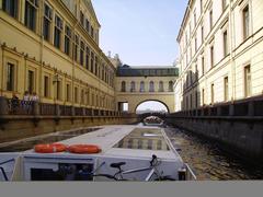 Hermitage Bridge over a calm body of water in a lush green park