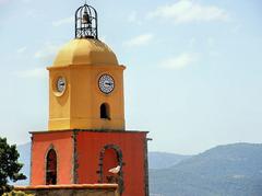 Seagull flying near a church bell tower in Saint-Tropez