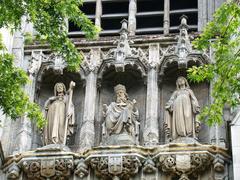 Detailed sculpted tower of Saint-Maurice church in Lille with three statues