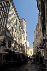 Street view of Rue Saint-Sauveur in La Rochelle, showcasing traditional half-timbered houses