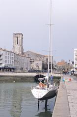 sailboat named Waikiki resting on its keel during low tide at La Rochelle harbor