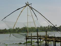 Scenic view of Fort Cochin with traditional Chinese fishing nets at sunset