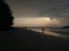 couples walking on Dharmadam beach shore in Kerala