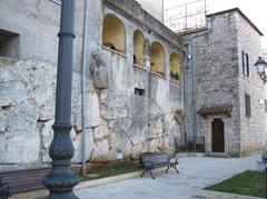 Panoramic view behind a wall with buildings and mountains in the background