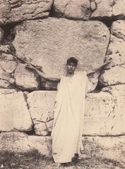 Boy wearing a toga in front of ancient Poligoneal walls at Alatri