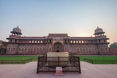 view of the Agra Fort courtyard with lush green gardens and historical buildings