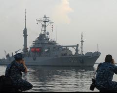 USNS Safeguard arriving in Jakarta with U.S. Navy personnel photographing the event