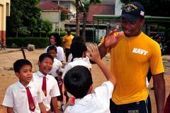 U.S. Navy sailor high-fives Indonesian students