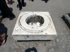 Trash bin inside a crumbling stone structure