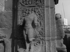 Close-up of a partially eroded statue with intricate details