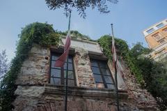 Casa Colombo monument with flags and reflections