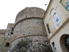 View of the northwest tower of Gallipoli Castle and the old fish market in Italy