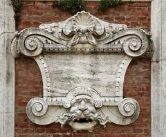 Fortezza Medicea (Siena) monument with intricate mask detail on a plaque