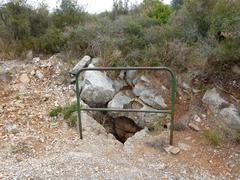 sinkhole near road with railing