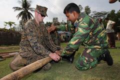 Bangladesh Armed Forces and U.S. Marine work together on bamboo ladder in Chittagong, Bangladesh