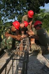 U.S. Marines and a Bangladesh Armed Forces soldier build a rebar support cage