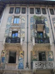 Facade of Casa Galimberti with intricate figures towards via Sirtori