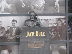 Legendary sportscaster Jack Buck speaking into a microphone