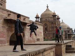 Boy leaping across mausoleum parapet at Khusru Bagh Park, Allahabad