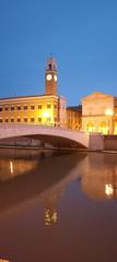 Pisa Ponte di Mezzo bridge over the Arno River with cityscape in the background