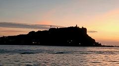 Kaohsiung Lighthouse at sunset with colorful clouds